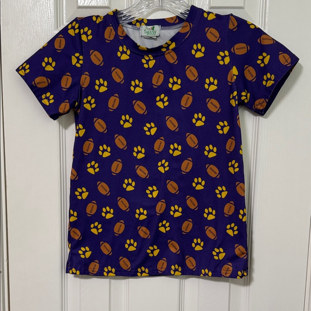Sassy Stitches LSU Tigers Purple Kids Tee with Football and Paw Print Pattern